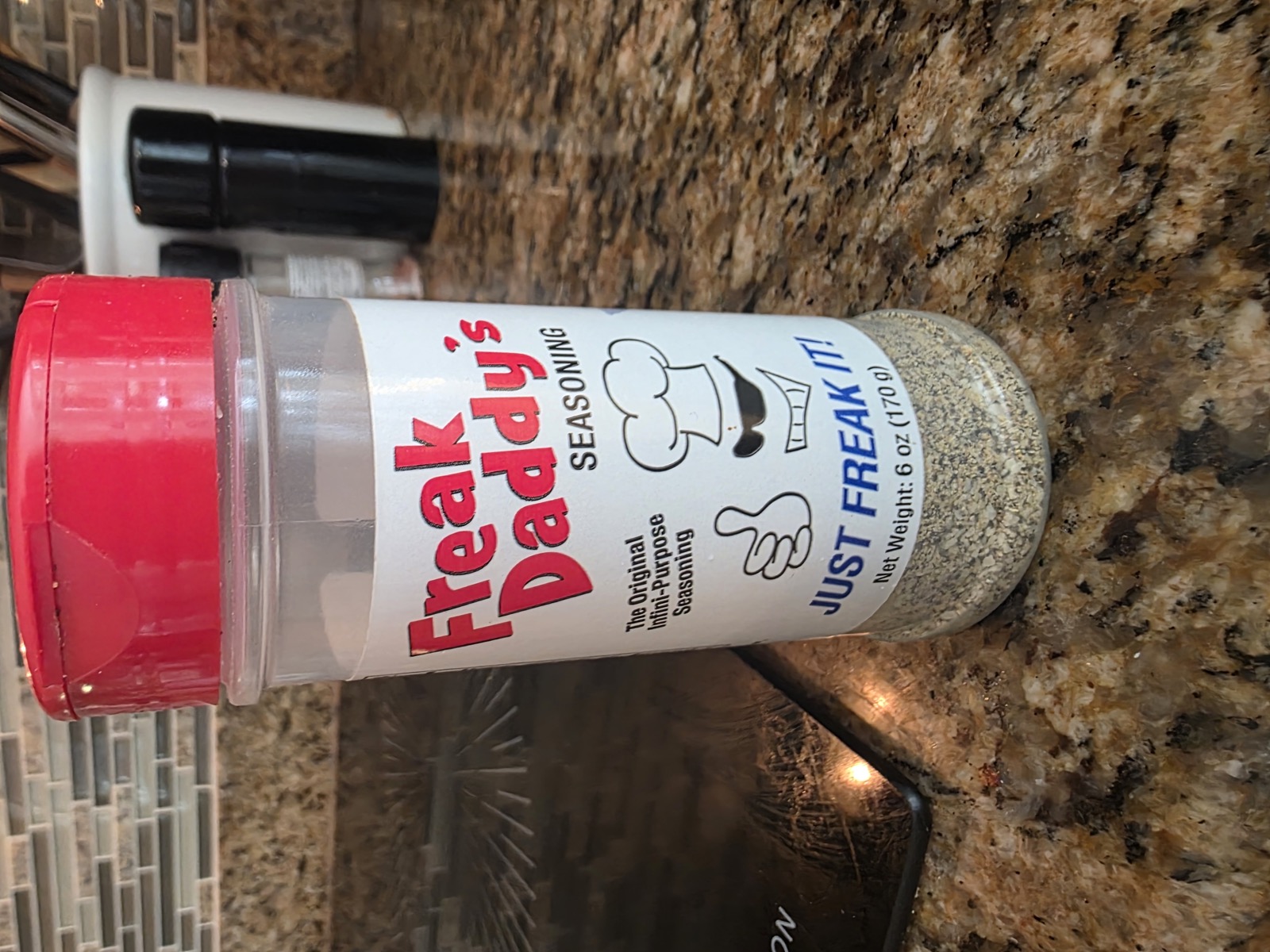 Freak Daddy seasoning bottle front label on granite
